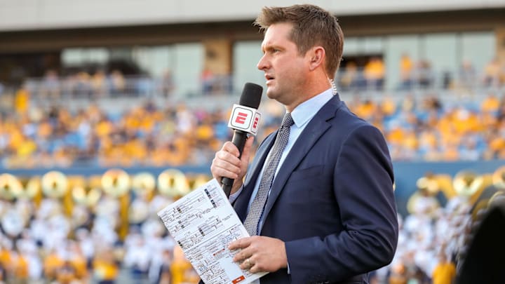 Oct 5, 2019; Morgantown, WV, USA; ESPN broadcaster Todd McShay talks along the sidelines during the third quarter at Mountaineer Field at Milan Puskar Stadium. Mandatory Credit: Ben Queen-Imagn Images