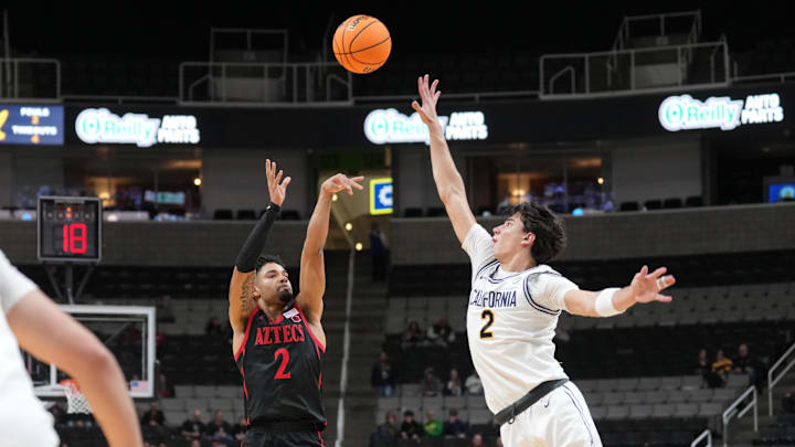 San Diego State Aztecs guard Nick Boyd (left) shoots against California Golden Bears guard Andrej Stojakovic (right). 