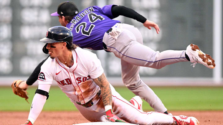 Jul 9, 2025; Boston, Massachusetts, USA; Boston Red Sox outfielder Jarren Duran (16) slides safely into third base ahead of a tag by Colorado Rockies third base Ryan McMahon (24) during the first inning at Fenway Park. Mandatory Credit: Brian Fluharty-Imagn Images
