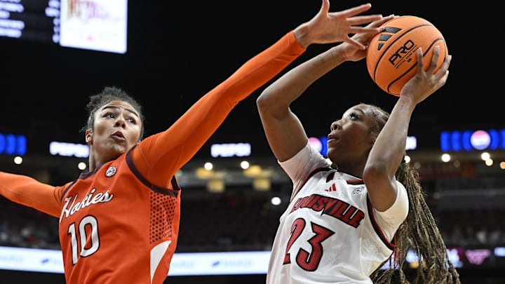 Jan 4, 2026; Louisville, Kentucky, USA;  Louisville Cardinals guard Skylar Jones (23) shoots against Virginia Tech Hokies forward Carys Baker (10) during the first half at KFC Yum! Center. Louisville defeated Virginia Tech 85-60. Mandatory Credit: Jamie Rhodes-Imagn Images