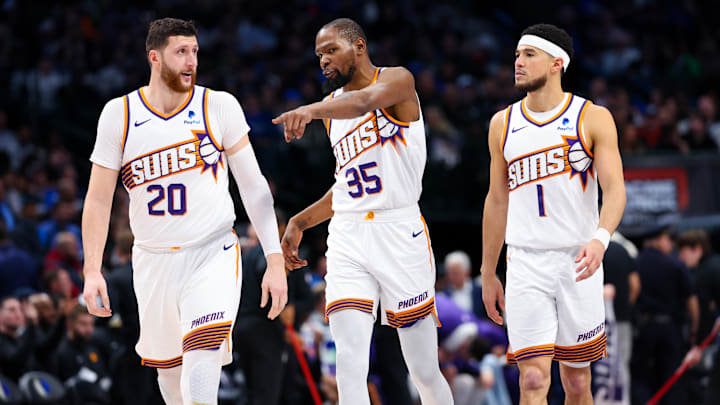 Jan 24, 2024; Dallas, Texas, USA;  Phoenix Suns forward Kevin Durant (35) and Phoenix Suns guard Devin Booker (1) and Phoenix Suns center Jusuf Nurkic (20) talk during the third quarter against the Dallas Mavericks at American Airlines Center. Mandatory Credit: Kevin Jairaj-Imagn Images