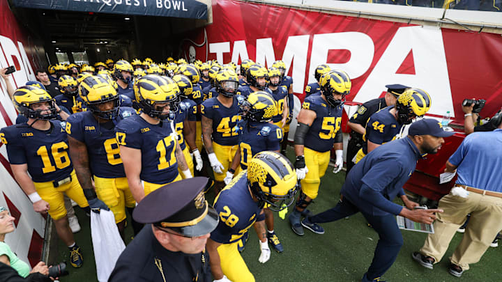 Dec 31, 2024; Tampa, FL, USA; Michigan Wolverines take the field for the ReliaQuest Bowl against the Alabama Crimson Tide at Raymond James Stadium. Mandatory Credit: Nathan Ray Seebeck-Imagn Images