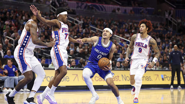 Jan 9, 2026; Orlando, Florida, USA; Orlando Magic guard Anthony Black (0) drives to the basket past Philadelphia 76ers guard Vj Edgecombe (77) in the fourth quarter at Kia Center. Mandatory Credit: Nathan Ray Seebeck-Imagn Images