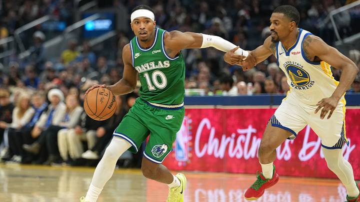Dec 25, 2025; San Francisco, California, USA; Dallas Mavericks guard Brandon Williams (10) dribbles against Golden State Warriors guard De'Anthony Melton (8) during the second quarter at Chase Center. Mandatory Credit: Darren Yamashita-Imagn Images