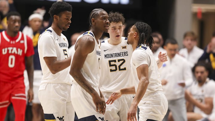 Feb 18, 2026; Morgantown, West Virginia, USA; West Virginia Mountaineers players celebrate after a defensive play during the first half against the Utah Utes at Hope Coliseum. Mandatory Credit: Ben Queen-Imagn Images