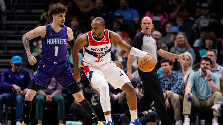 Mar 1, 2025; Charlotte, North Carolina, USA; Washington Wizards forward Khris Middleton (32) backs down Charlotte Hornets guard LaMelo Ball (1) during the first quarter at Spectrum Center. Mandatory Credit: Scott Kinser-Imagn Images