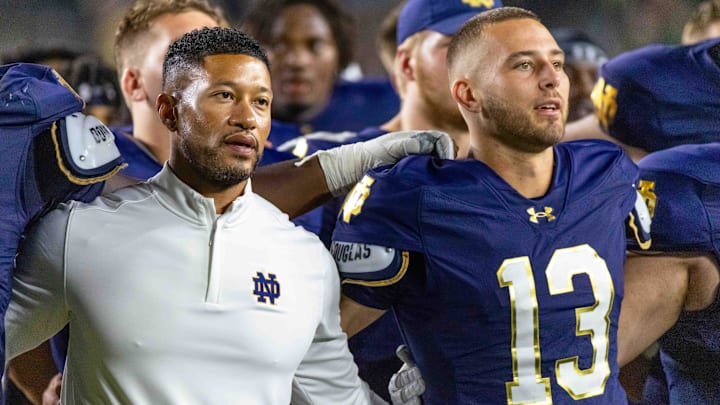 Sep 20, 2025; South Bend, Indiana, USA; Notre Dame Fighting Irish head coach Marcus Freeman and quarterback CJ Carr (13) sing the alma mater after beating the Purdue Boilermakers at Notre Dame Stadium. Sep 20, 2025; South Bend, Indiana, USA; Notre Dame Fighting Irish head coach Marcus Freeman and quarterback CJ Carr (13) sing the alma mater after beating the Purdue Boilermakers at Notre Dame Stadium.