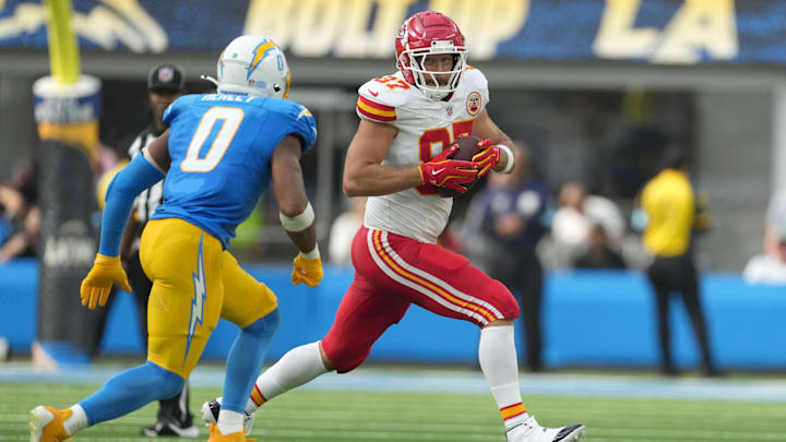 Sep 29, 2024; Inglewood, California, USA; Kansas City Chiefs tight end Travis Kelce (87) runs against Los Angeles Chargers linebacker Daiyan Henley (0) in the second half at SoFi Stadium. Mandatory Credit: Kirby Lee-Imagn Images