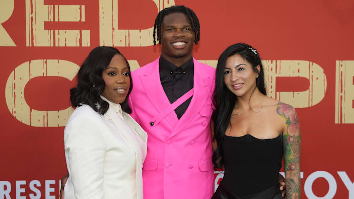 Apr 24, 2025; Green Bay, WI, USA; Colorado Buffaloes wide receiver Travis Hunter with his mother Ferrante Harris and his fiancee Leanna Lenee on the red carpet before the 2025 NFL Draft at Lambeau Field. Mandatory Credit: Kirby Lee-Imagn Images