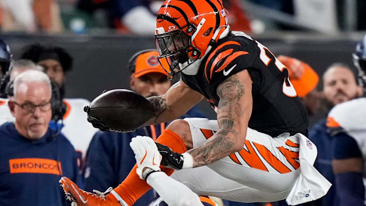 Cincinnati Bengals running back Chase Brown (30) leaps over Denver Broncos safety Brandon Jones (22) in the second quarter of the NFL Week 17 game between the Cincinnati Bengals and the Denver Broncos at Paycor Stadium in downtown Cincinnati on Saturday, Dec. 28, 2024.