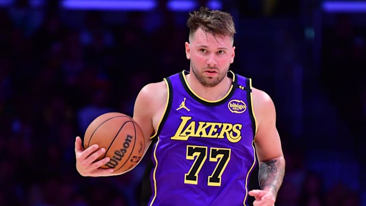 Feb 25, 2025; Los Angeles, California, USA; Los Angeles Lakers guard Luka Doncic (77) dribbles the ball against the Dallas Mavericks during the second half at Crypto.com Arena. Mandatory Credit: Gary A. Vasquez-Imagn Images