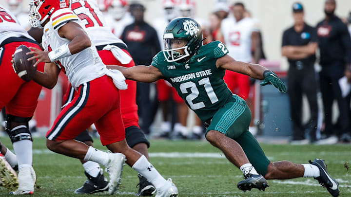 Michigan State defensive back Dillon Tatum (21) tackles Maryland quarterback Taulia Tagovailoa (3) during the second half of MSU's 31-9 loss on Saturday, Sept. 23, 2023, in East Lansing.