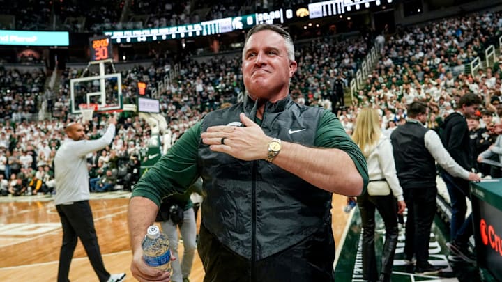 Michigan State's new football coach Pat Fitzgerald pats his heart at the crowd in attendance for the Spartans basketball game against Iowa on Tuesday, Dec. 2, 2025, at the Breslin Center in East Lansing. Michigan State's new football coach Pat Fitzgerald pats his heart at the crowd in attendance for the Spartans basketball game against Iowa on Tuesday, Dec. 2, 2025, at the Breslin Center in East Lansing.