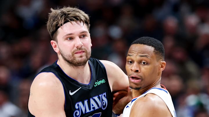 Dec 20, 2023; Dallas, Texas, USA;  Dallas Mavericks guard Luka Doncic (77) and LA Clippers guard Russell Westbrook (0) battle for position during the first quarter at American Airlines Center. Mandatory Credit: Kevin Jairaj-USA TODAY Sports