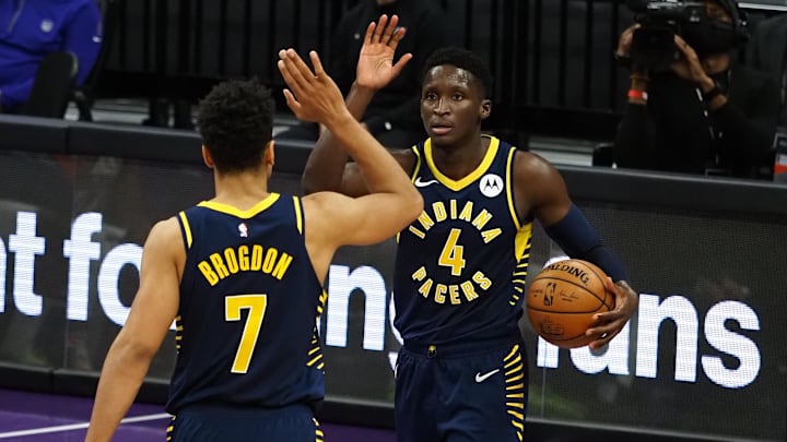 Jan 11, 2021; Sacramento, California, USA; Indiana Pacers guard Malcom Brogdon (7) high fives guard Victor Oladipo (4) after a play against the Sacramento Kings during the fourth quarter at Golden 1 Center. Mandatory Credit: Kelley L Cox-Imagn Images