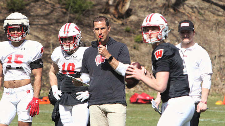 Wisconsin coach Luke Fickell watches his quarterbacks throw passes during practice just outside Camp Randall Stadium in Madison, Wisconsin on Saturday April 7, 2024.