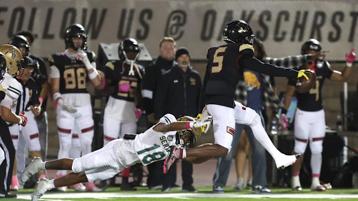 Oaks Christian's Davon Benjamin leaps free from St. Bonaventure's Darrien Johnson return an interception for a touchdown in the third quarter of Oaks Christian's win over visiting St. Bonaventure Friday at Redell Field. The Lions won, 35-0.