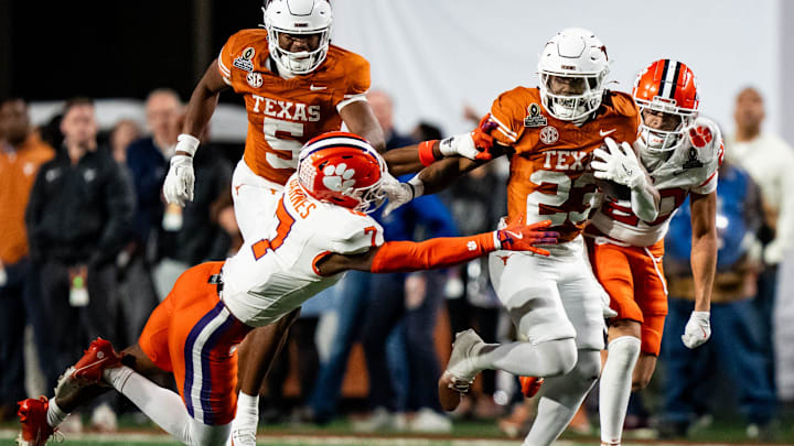 Texas Longhorns running back Jaydon Blue evades a tackle from Clemson Tigers safety Khalil Barnes to run for a touchdown.