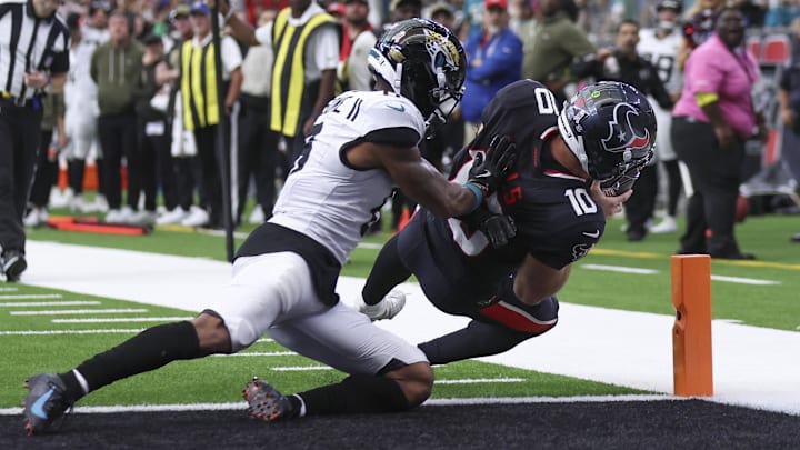 Nov 9, 2025; Houston, Texas, USA; Houston Texans quarterback Davis Mills (10) runs with the ball and scores a touchdown as Jacksonville Jaguars cornerback Greg Newsome II (6) defends during the fourth quarter at NRG Stadium. Mandatory Credit: Troy Taormina-Imagn Images