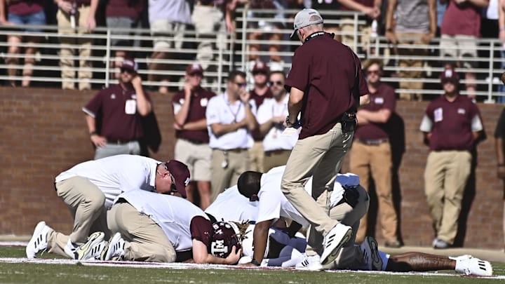 Oct 1, 2022; Starkville, Mississippi, USA; Texas A&M Aggies staff assist defensive back Jaylon Jones (17) after an injury against the Mississippi State Bulldogs during the first quarter at Davis Wade Stadium at Scott Field. Mandatory Credit: Matt Bush-Imagn Images
