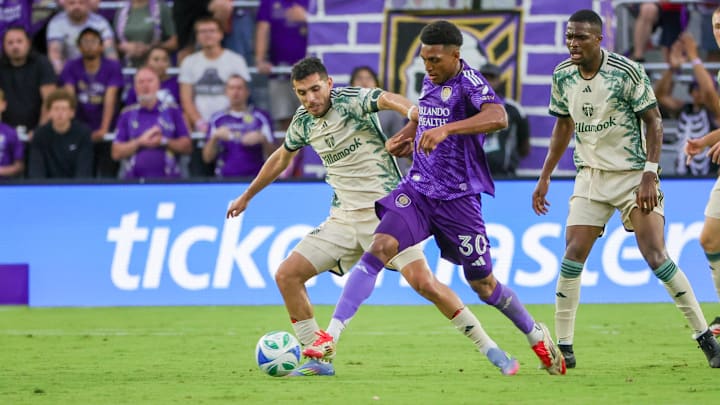 May 24, 2025; Orlando, Florida, USA; Orlando City defender Alex Freeman (30) battles for the ball against Portland Timbers midfielder Cristhian Paredes (17) during the first half at Inter&Co Stadium. Mandatory Credit: Mike Watters-Imagn Images