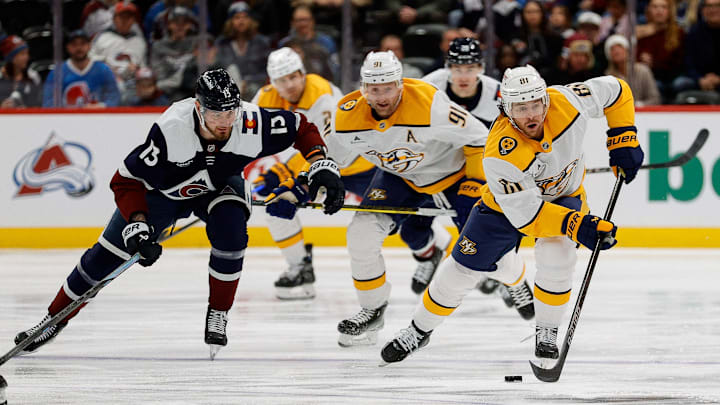 Dec 14, 2024; Denver, Colorado, USA; Nashville Predators center Jonathan Marchessault (81) controls the puck ahead of center Steven Stamkos (91) and Colorado Avalanche right wing Valeri Nichushkin (13) in the first period at Ball Arena. Mandatory Credit: Isaiah J. Downing-Imagn Images