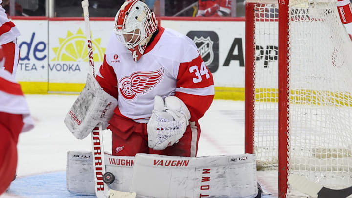 Apr 16, 2025; Newark, New Jersey, USA; Detroit Red Wings goaltender Alex Lyon (34) makes a save against the New Jersey Devils during the second period at Prudential Center. Mandatory Credit: Ed Mulholland-Imagn Images