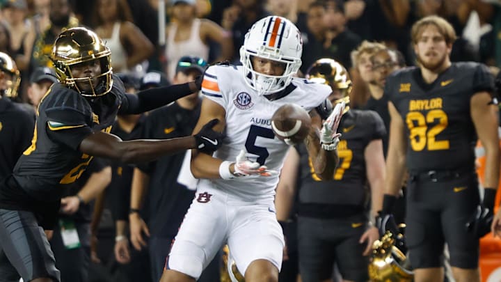 Aug 29, 2025; Waco, Texas, USA;  Auburn Tigers wide receiver Horatio Fields (5) catchesa pass against Baylor Bears safety Cameren Jenkins (23) during the second half at McLane Stadium. Mandatory Credit: Chris Jones-Imagn Images