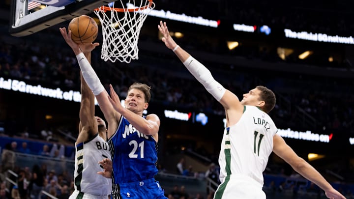 Nov 11, 2023; Orlando, Florida, USA; Orlando Magic center Moritz Wagner (21) shoots over Milwaukee Bucks center Brook Lopez (11) and Milwaukee Bucks forward MarJon Beauchamp (3) during the first half at Amway Center. Mandatory Credit: Matt Pendleton-Imagn Images Nov 11, 2023; Orlando, Florida, USA; Orlando Magic center Moritz Wagner (21) shoots over Milwaukee Bucks center Brook Lopez (11) and Milwaukee Bucks forward MarJon Beauchamp (3) during the first half at Amway Center. Mandatory Credit: Matt Pendleton-Imagn Images