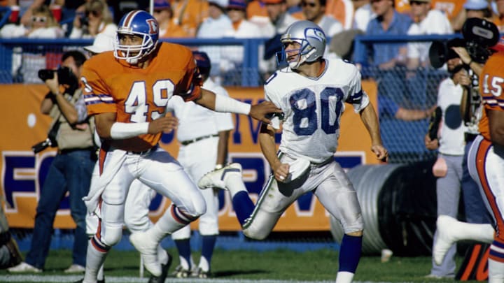 Oct 26, 1986; Denver, CO, USA; FILE PHOTO; Denver Broncos defensive back Dennis Smith(49) and Seattle Seahawks receiver Steve Largent (80) in action at Mile High Stadium. Mandatory Credit: Manny Rubio-Imagn Images Oct 26, 1986; Denver, CO, USA; FILE PHOTO; Denver Broncos defensive back Dennis Smith(49) and Seattle Seahawks receiver Steve Largent (80) in action at Mile High Stadium. Mandatory Credit: Manny Rubio-Imagn Images