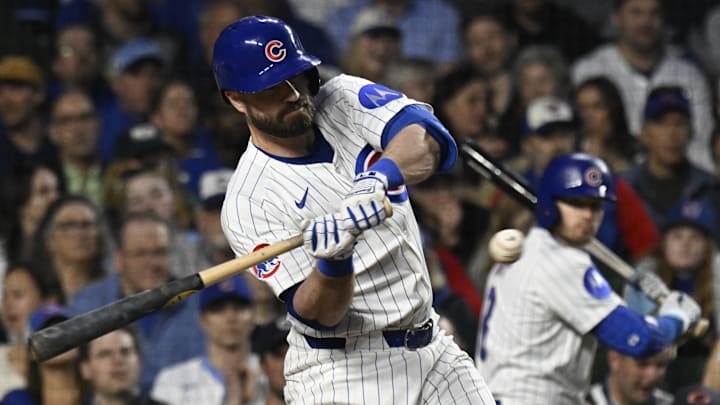 May 6, 2025; Chicago, Illinois, USA;  Chicago Cubs infielder Jon Berti (5) hits an RBI single during the fifth inning against the San Francisco Giants at Wrigley Field. Mandatory Credit: Matt Marton-Imagn Images