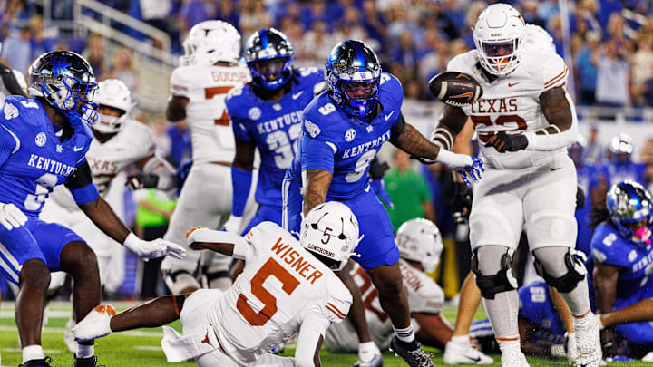 Oct 18, 2025; Lexington, Kentucky, USA; Texas Longhorns running back Quintrevion Wisner (5) has the ball knocked away by Kentucky Wildcats defensive back Cam Dooley (18) in the end zone during the second quarter at Kroger Field. Mandatory Credit: Jordan Prather-Imagn Images Oct 18, 2025; Lexington, Kentucky, USA; Texas Longhorns running back Quintrevion Wisner (5) has the ball knocked away by Kentucky Wildcats defensive back Cam Dooley (18) in the end zone during the second quarter at Kroger Field. Mandatory Credit: Jordan Prather-Imagn Images