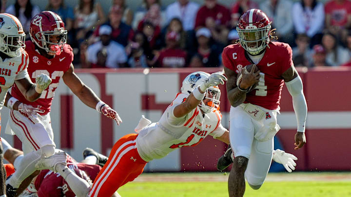 Nov 16, 2024; Tuscaloosa, AL, USA; Mercer safety Chris Joines (14) lunges to try and bring down Alabama Crimson Tide quarterback Jalen Milroe (4) at Bryant-Denny Stadium