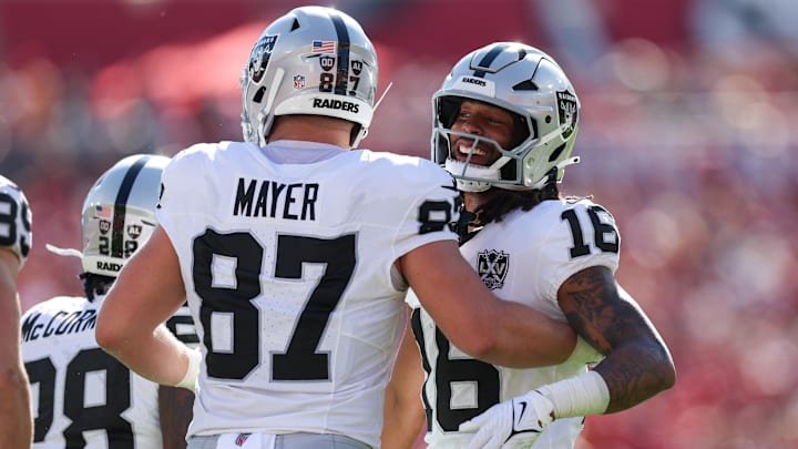 Dec 8, 2024; Tampa, Florida, USA; Las Vegas Raiders wide receiver Jakobi Meyers (16) and tight end Michael Mayer (87) celebrate after a play against the Tampa Bay Buccaneers in the first quarter at Raymond James Stadium. Mandatory Credit: Nathan Ray Seebeck-Imagn Images