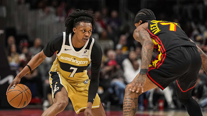 Feb 24, 2026; Atlanta, Georgia, USA; Washington Wizards guard Bub Carrington (7) dribbles against Atlanta Hawks guard Nickeil Alexander-Walker (7) during the first half at State Farm Arena. Mandatory Credit: Dale Zanine-Imagn Images