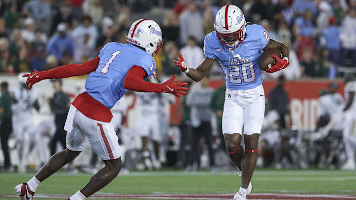 Houston Cougars defensive back Jeremiah Wilson (20) celebrates with defensive back Latrell McCutchin Sr. (1)