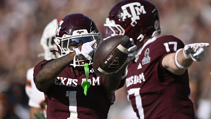 Texas A&M Aggies wide receiver Mario Craver and Texas A&M Aggies tight end Theo Melin Öhrström celebrate a first down against the Miami Hurricanes during the second half of the first round game of the CFP National Playoff at Kyle Field. 