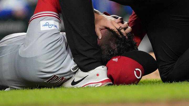 May 5, 2026; Chicago, Illinois, USA; Cincinnati Reds pitcher Emilio Pagan (15) reacts to an injury during the ninth inning against the Chicago Cubs at Wrigley Field. Mandatory Credit: David Banks-Imagn Images