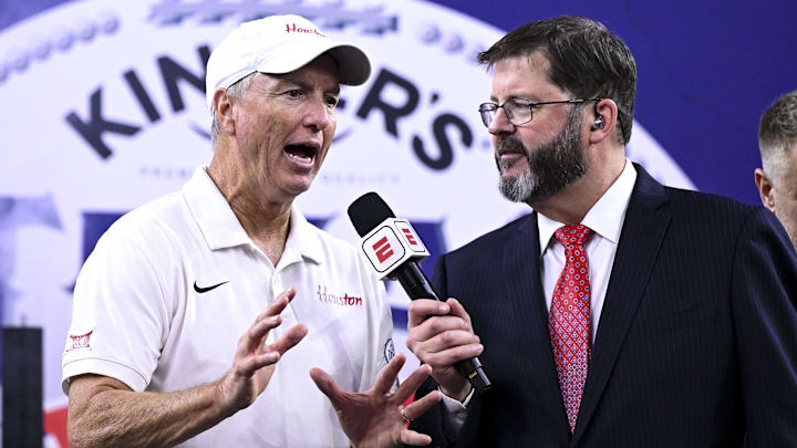 Dec 27, 2025; Houston, TX, USA; Houston Cougars head coach Willie Fritz speak with an ESPN sports caster after the win over Louisiana State Tigers at NRG Stadium. Mandatory Credit: Maria Lysaker-Imagn Images 