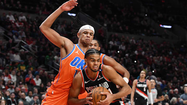 Nov 1, 2024; Portland, Oregon, USA; Oklahoma City Thunder forward Ousmane Dieng (13) defends against Portland Trailblazers guard/forward Ryan Rupert (21) during the fourth quarter at Moda Center. Mandatory Credit: Brian Murphy-Imagn Images