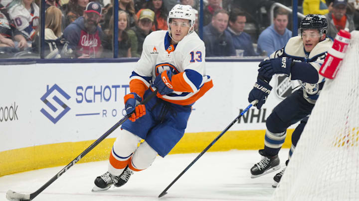 Oct 30, 2024; Columbus, Ohio, USA; New York Islanders center Mathew Barzal (13) skates with the puck against Columbus Blue Jackets defenseman Jordan Harris (22) in the first period at Nationwide Arena. Mandatory Credit: Aaron Doster-Imagn Images