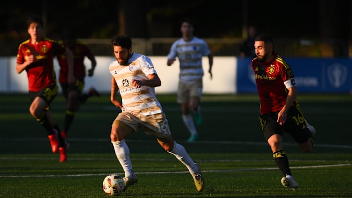 May 8, 2024; Tukwila, Washington, USA; Louisville City FC forward Adrien Perez (16) advances the ball while defended by Seattle Sounders FC midfielder Alex Roldan (16) during the first half at Starfire Sports Complex. Mandatory Credit: Steven Bisig-Imagn Images