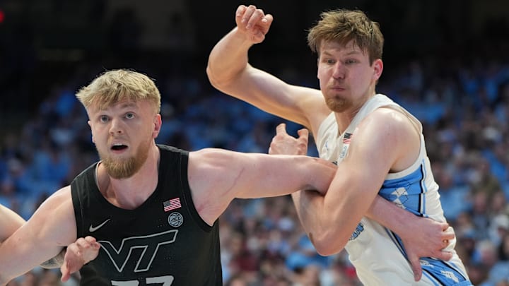 Feb 28, 2026; Chapel Hill, North Carolina, USA; Virginia Tech Hokies center Antonio Dorn (77) and North Carolina Tar Heels center Henri Veesaar (13) fight for position in the second half at Dean E. Smith Center. Mandatory Credit: Bob Donnan-Imagn Images
