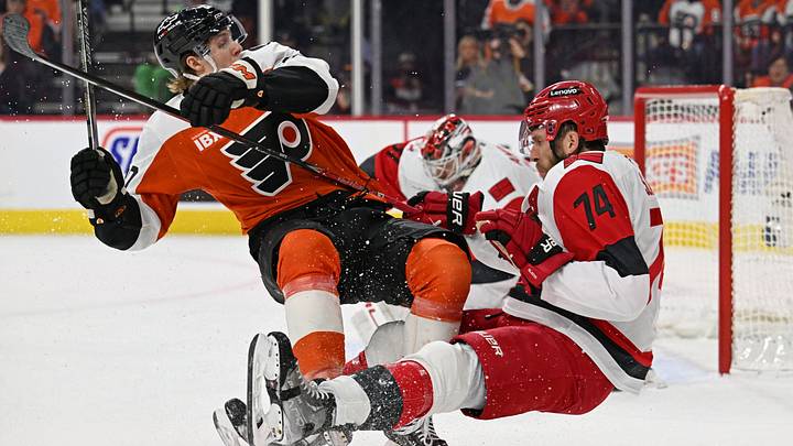 May 7, 2026; Philadelphia, Pennsylvania, USA; Philadelphia Flyers left wing Alex Bump (20) and Carolina Hurricanes defenseman Jaccob Slavin (74) battle during the first period in game three of the second round of the 2026 Stanley Cup Playoffs at Xfinity Mobile Arena.