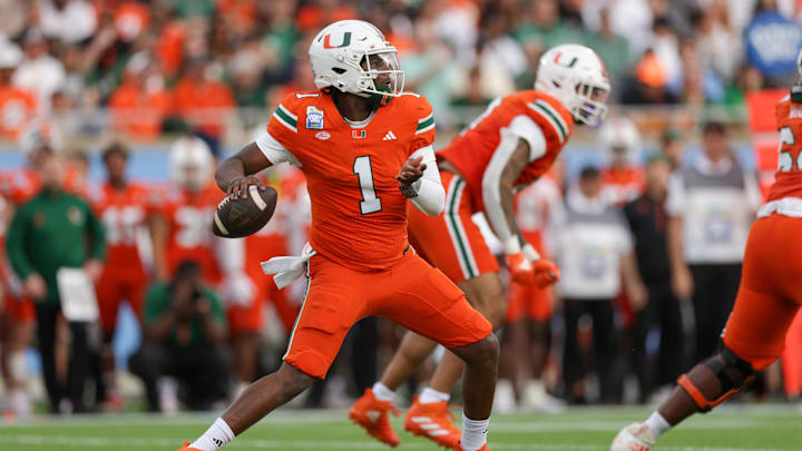 Dec 28, 2024; Orlando, FL, USA; Miami Hurricanes quarterback Cam Ward (1) drops back to pass against the Iowa State Cyclones in the first quarter during the Pop Tarts bowl at Camping World Stadium. Mandatory Credit: Nathan Ray Seebeck-Imagn Images