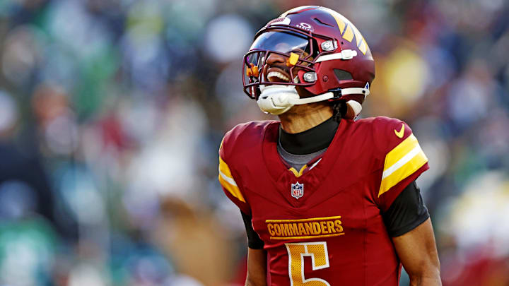Dec 22, 2024; Landover, Maryland, USA; Washington Commanders quarterback Jayden Daniels (5) celebrates after throwing a touchdown during the fourth quarter against the Philadelphia Eagles at Northwest Stadium. Mandatory Credit: Peter Casey-Imagn Images