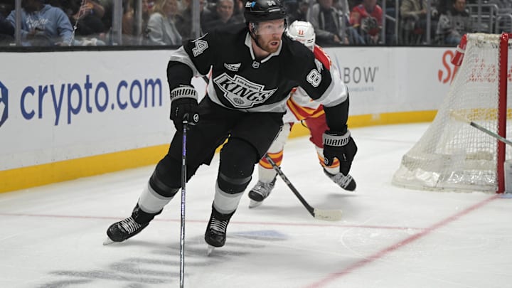 Apr 17, 2025; Los Angeles, California, USA;  Los Angeles Kings defenseman Vladislav Gavrikov (84) controls the puck during the second period at Crypto.com Arena. Mandatory Credit: Jayne Kamin-Oncea-Imagn Images