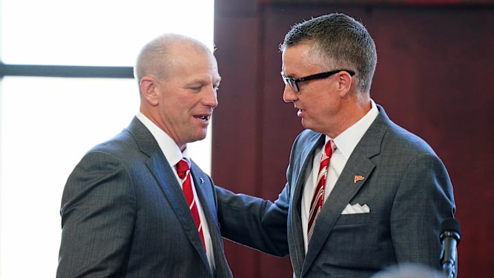 Jan 13, 2024; Tuscaloosa, AL, USA; University of Alabama athletic director Greg Byrne (right) embraces their new head football coach Kalen DeBoer (left) during a press conference in the North end zone at Bryant-Denny Stadium. Mandatory Credit: John David Mercer-Imagn Images