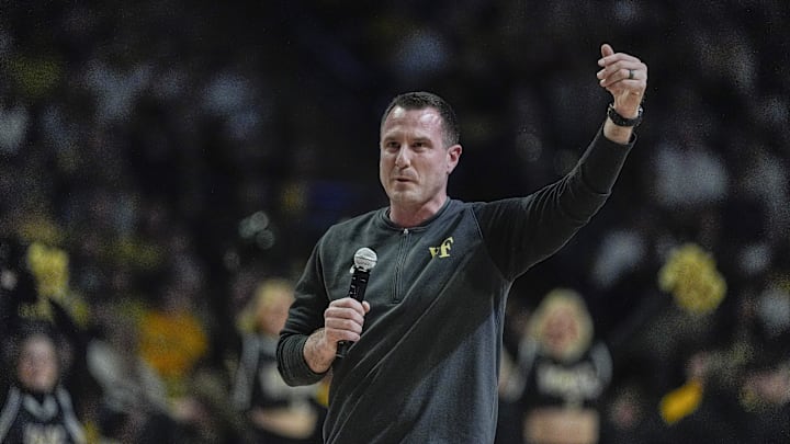 Jan 25, 2025; Winston-Salem, North Carolina, USA; New Wake Forest Demon Deacons football coach Jake Dickert speaks to the fans during the first half between the Wake Forest Demon Deacons and the Duke Blue Devils at Lawrence Joel Veterans Memorial Coliseum. Mandatory Credit: Jim Dedmon-Imagn Images Jan 25, 2025; Winston-Salem, North Carolina, USA; New Wake Forest Demon Deacons football coach Jake Dickert speaks to the fans during the first half between the Wake Forest Demon Deacons and the Duke Blue Devils at Lawrence Joel Veterans Memorial Coliseum. Mandatory Credit: Jim Dedmon-Imagn Images