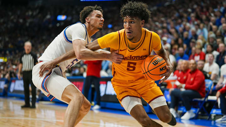 Feb 3, 2025; Lawrence, Kansas, USA; Iowa State Cyclones guard Curtis Jones (5) drives against Kansas Jayhawks guard Zeke Mayo (5) during the first half at Allen Fieldhouse. Mandatory Credit: Jay Biggerstaff-Imagn Images